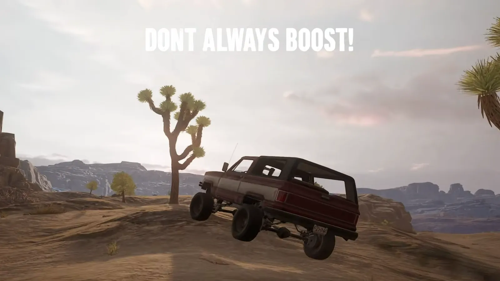 A PUBG pickup truck catching air over a crest on Miramar sand, showing why you should not always hold boost